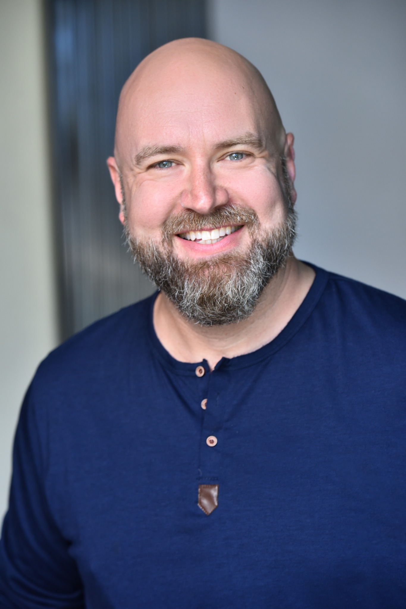 Adrian Honner smiling in a warm professional portrait